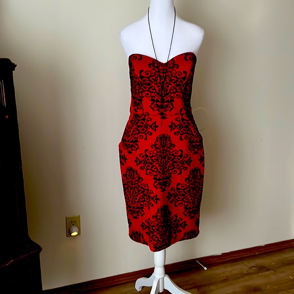 Red cocktail dress with romantic tapestry design.